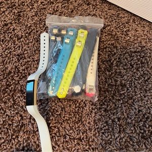 Fitbit with bag of colorful Bands